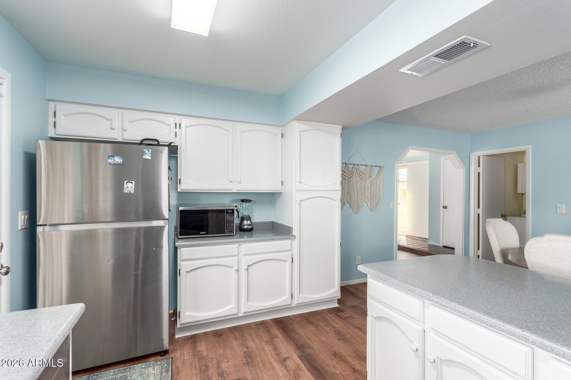 4826 West Wagoner Road Glendale, AZ 85308 - Photo 13 of 26 a kitchen with a refrigerator a sink and cabinets