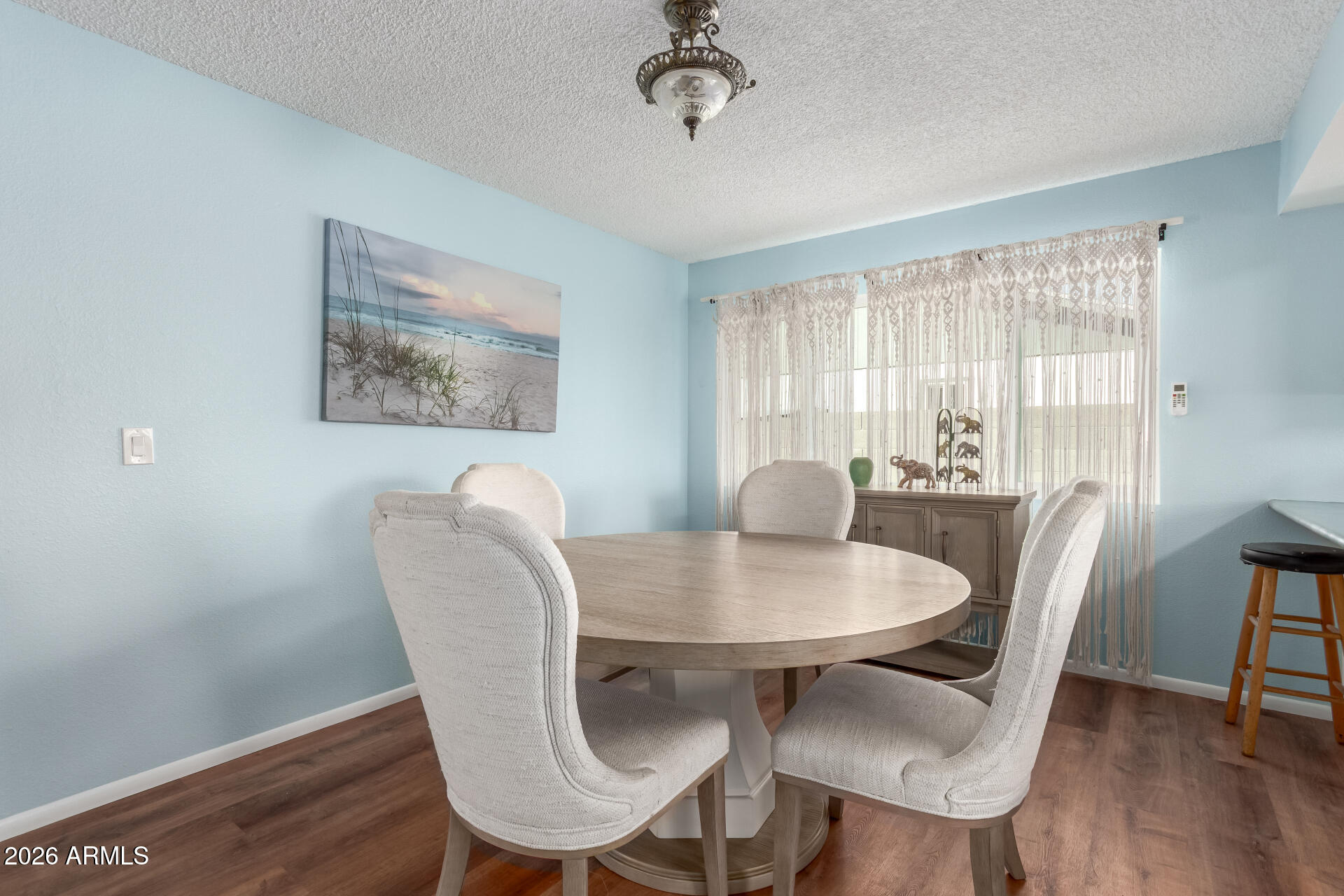4826 West Wagoner Road Glendale, AZ 85308 - Photo 8 of 26 a view of a dining room with furniture window and wooden floor