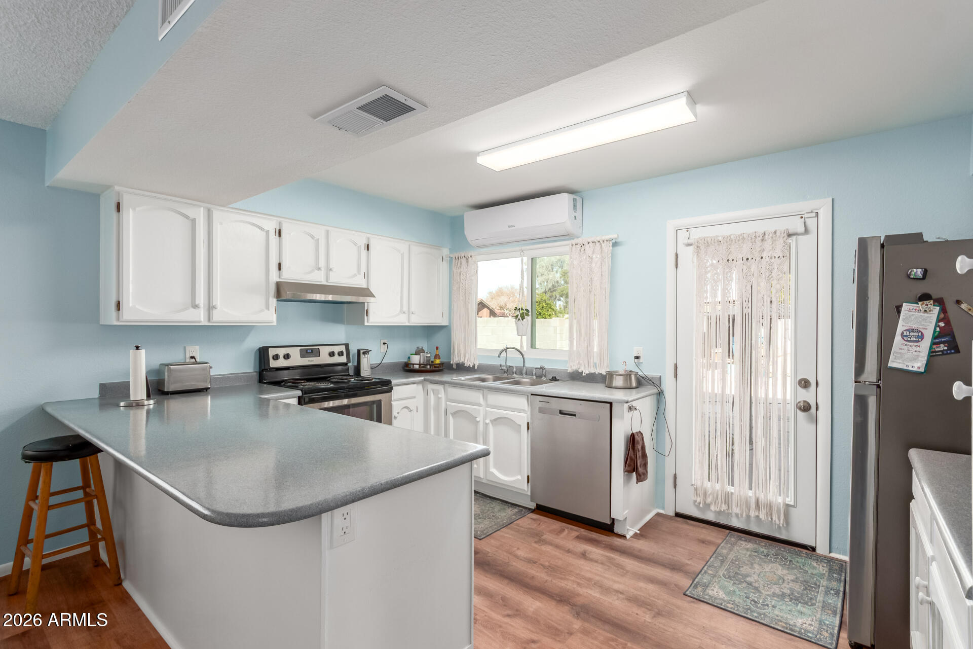 4826 West Wagoner Road Glendale, AZ 85308 - Photo 9 of 26 a kitchen with stainless steel appliances granite countertop a sink stove refrigerator and cabinets