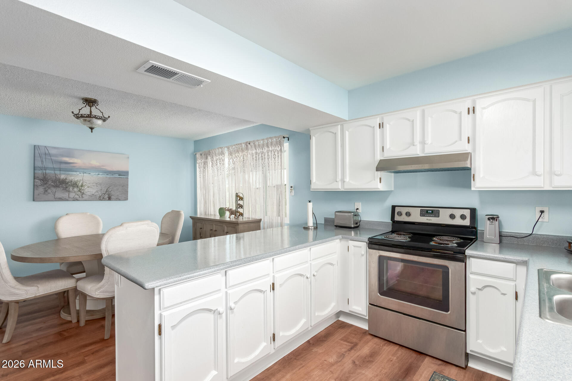 4826 West Wagoner Road Glendale, AZ 85308 - Photo 10 of 26 a kitchen with cabinets appliances a sink and a window