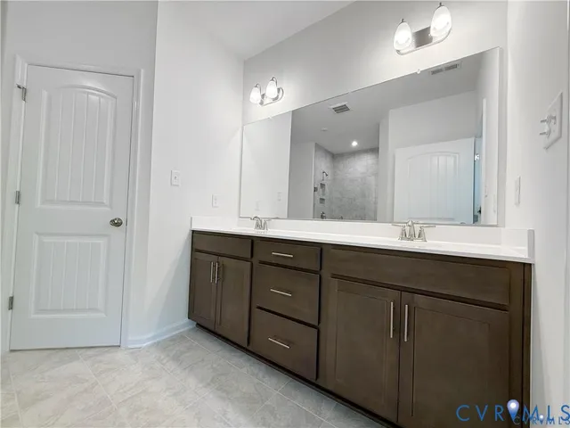a bathroom with a double vanity sink and mirror