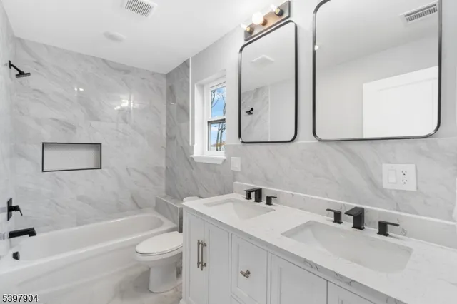 a bathroom with a toilet sink and bathtub