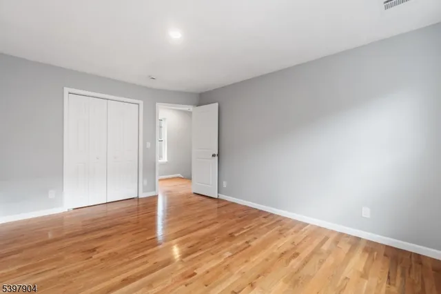 a view of an empty room and wooden floor