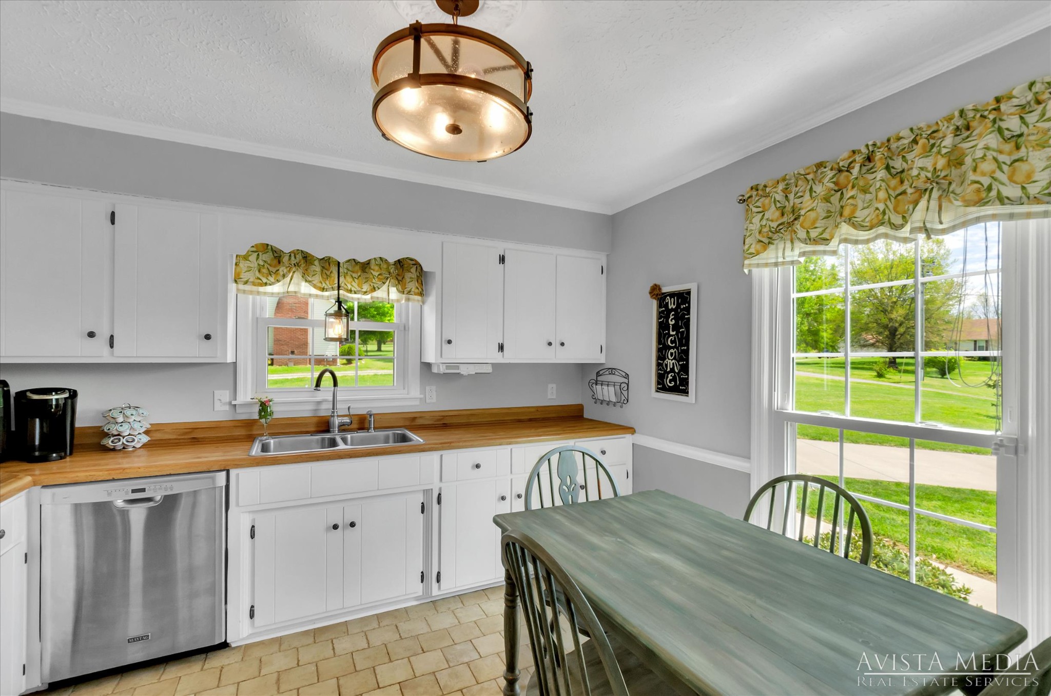 6348 Gum Station Road Springfield, TN 37172 - Photo 6 of 19 a kitchen with stainless steel appliances granite countertop a sink a stove a dining table and chairs with wooden floor