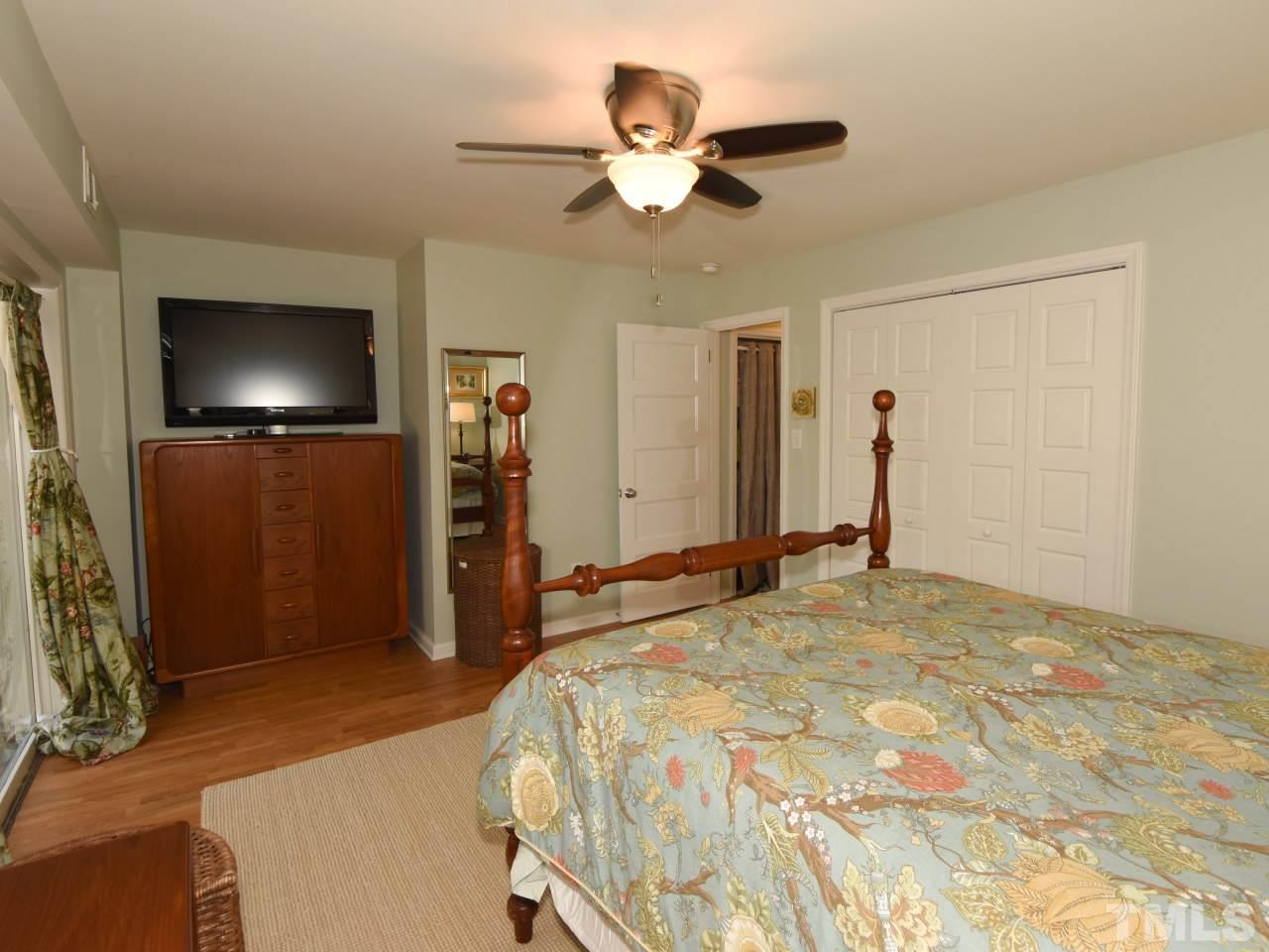 616 Macon Place Raleigh, NC 27609 - Photo 15 of 25 a bedroom with a bed and a flat screen tv