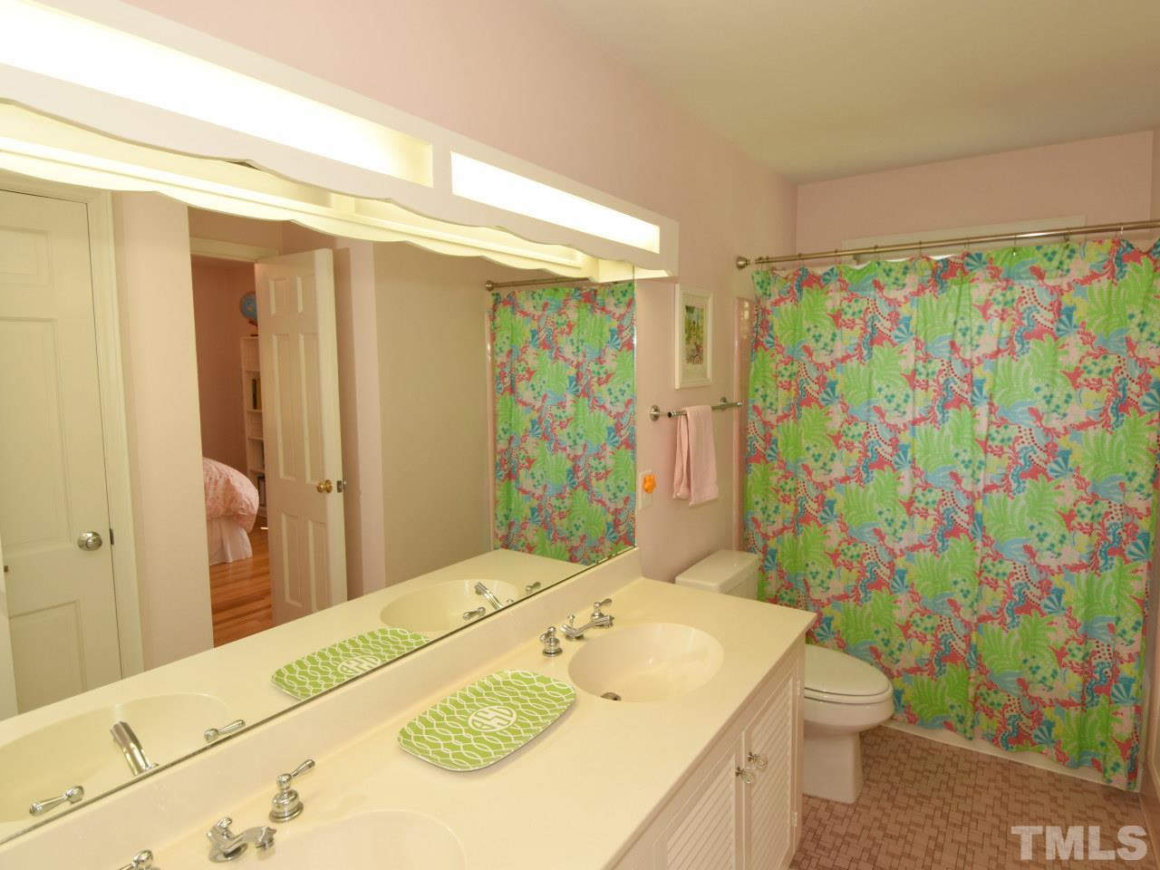 616 Macon Place Raleigh, NC 27609 - Photo 19 of 25 a en suite bathroom with a granite countertop sink a toilet and shower