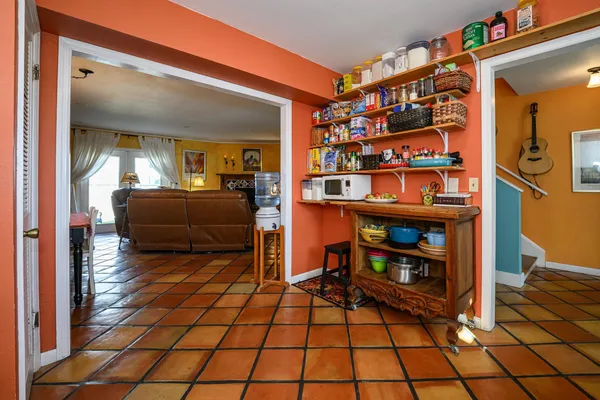 a living room with furniture a table and a floor to ceiling window