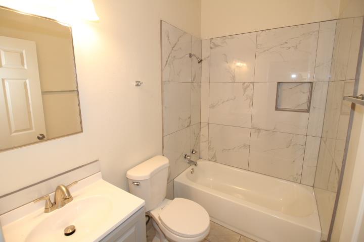 90 Magnolia Avenue Lemoore, CA 93245 - Photo 13 of 17 a bathroom with a sink toilet and shower