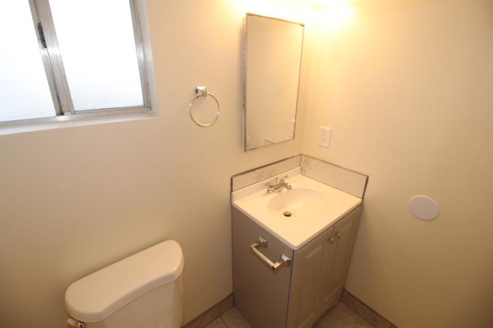 90 Magnolia Avenue Lemoore, CA 93245 - Photo 14 of 17 a bathroom with a toilet sink vanity and mirror