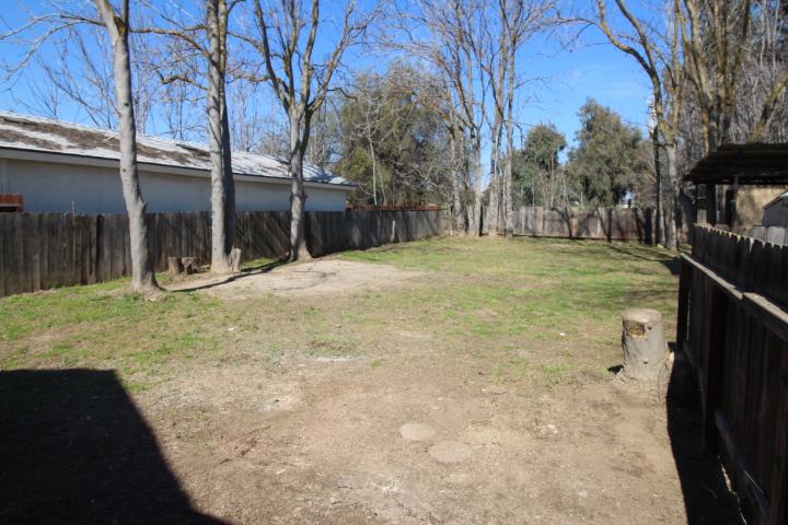 90 Magnolia Avenue Lemoore, CA 93245 - Photo 16 of 17 a view of a yard with wooden fence