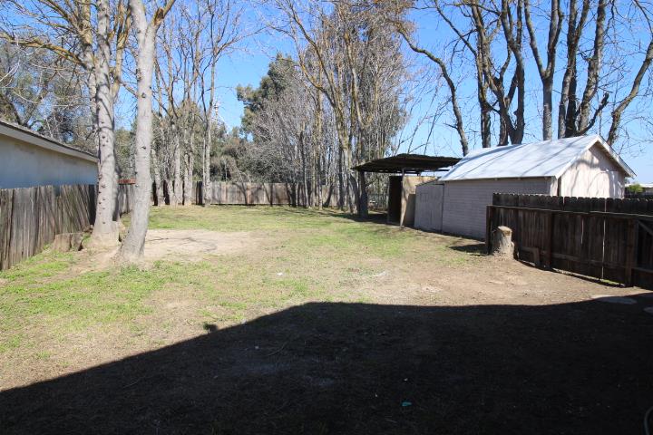 90 Magnolia Avenue Lemoore, CA 93245 - Photo 17 of 17 a view of a yard with an umbrella