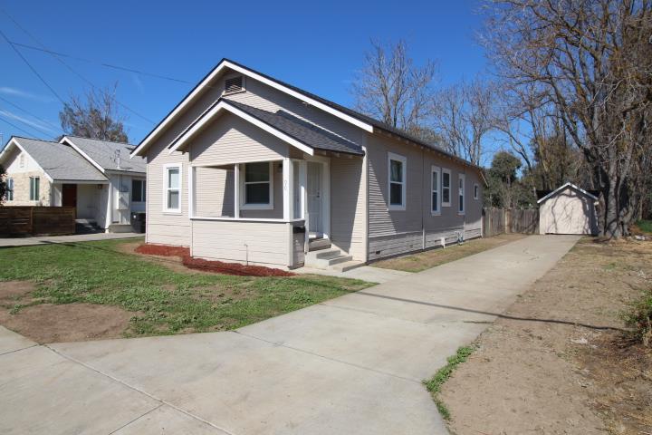 90 Magnolia Avenue Lemoore, CA 93245 - Photo 2 of 17 a front view of a house with a yard and garage