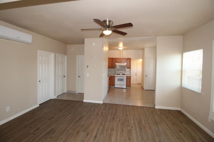 90 Magnolia Avenue Lemoore, CA 93245 - Photo 5 of 17 a view of empty room with wooden floor and window