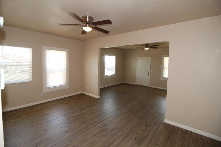 90 Magnolia Avenue Lemoore, CA 93245 - Photo 6 of 17 a view of an empty room with wooden floor and a window