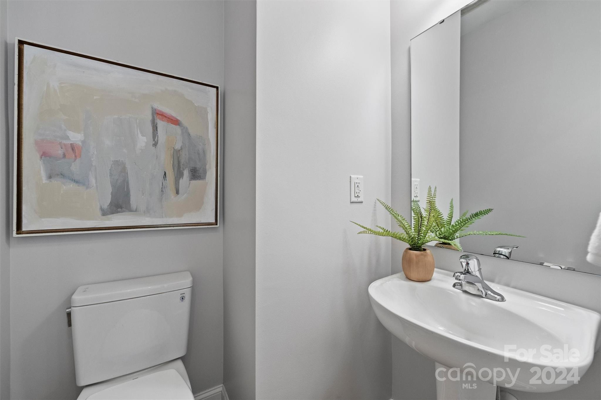 323 Hurston Circle Charlotte, NC 28208 - Photo 11 of 27 a bathroom with a sink and a mirror