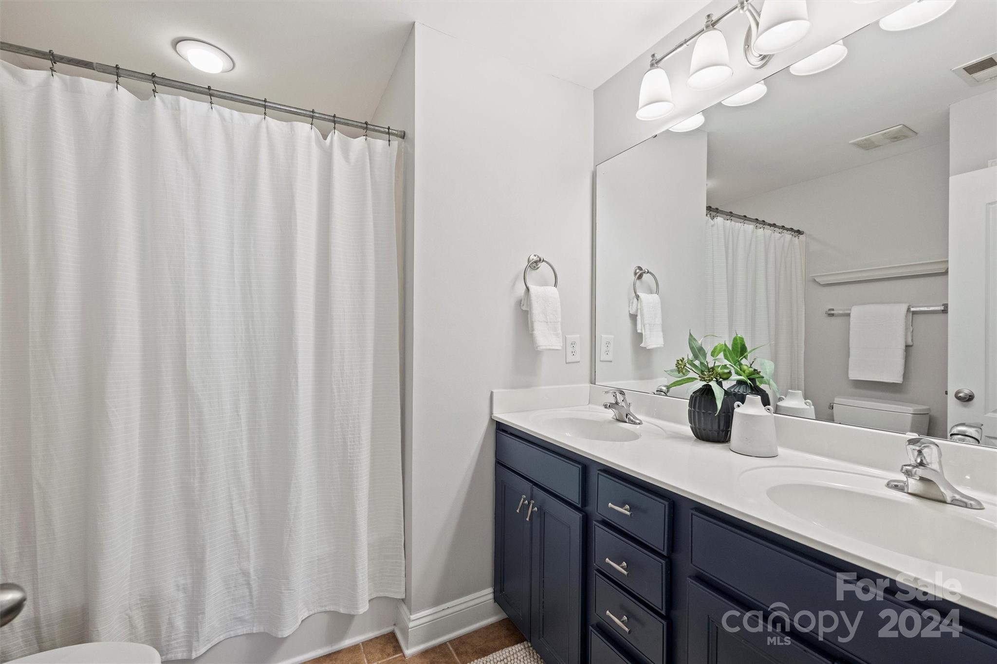 323 Hurston Circle Charlotte, NC 28208 - Photo 15 of 27 a bathroom with a double vanity sink and a mirror