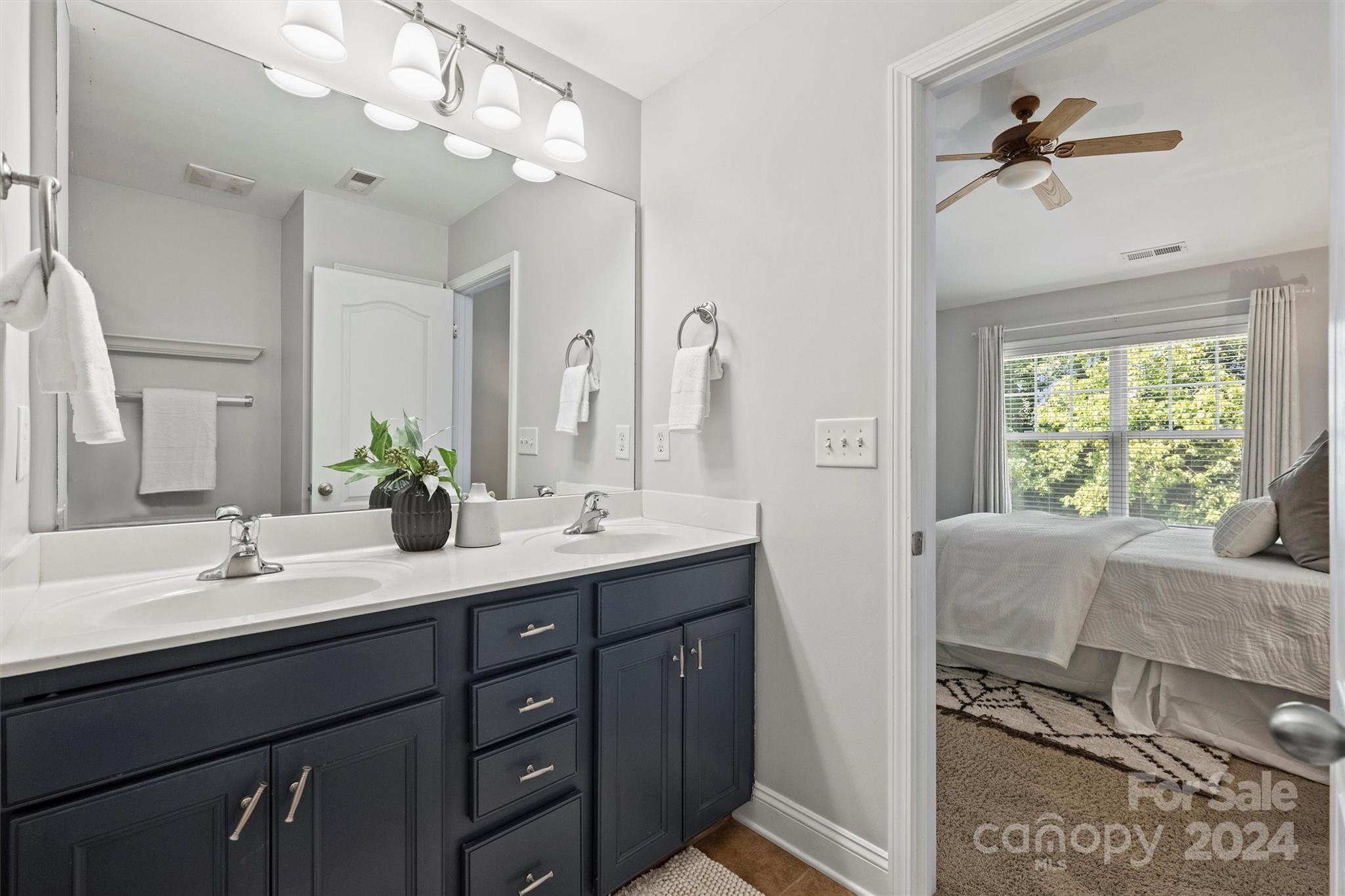 323 Hurston Circle Charlotte, NC 28208 - Photo 16 of 27 a en suite bathroom with double vanity a mirror and a bathtub