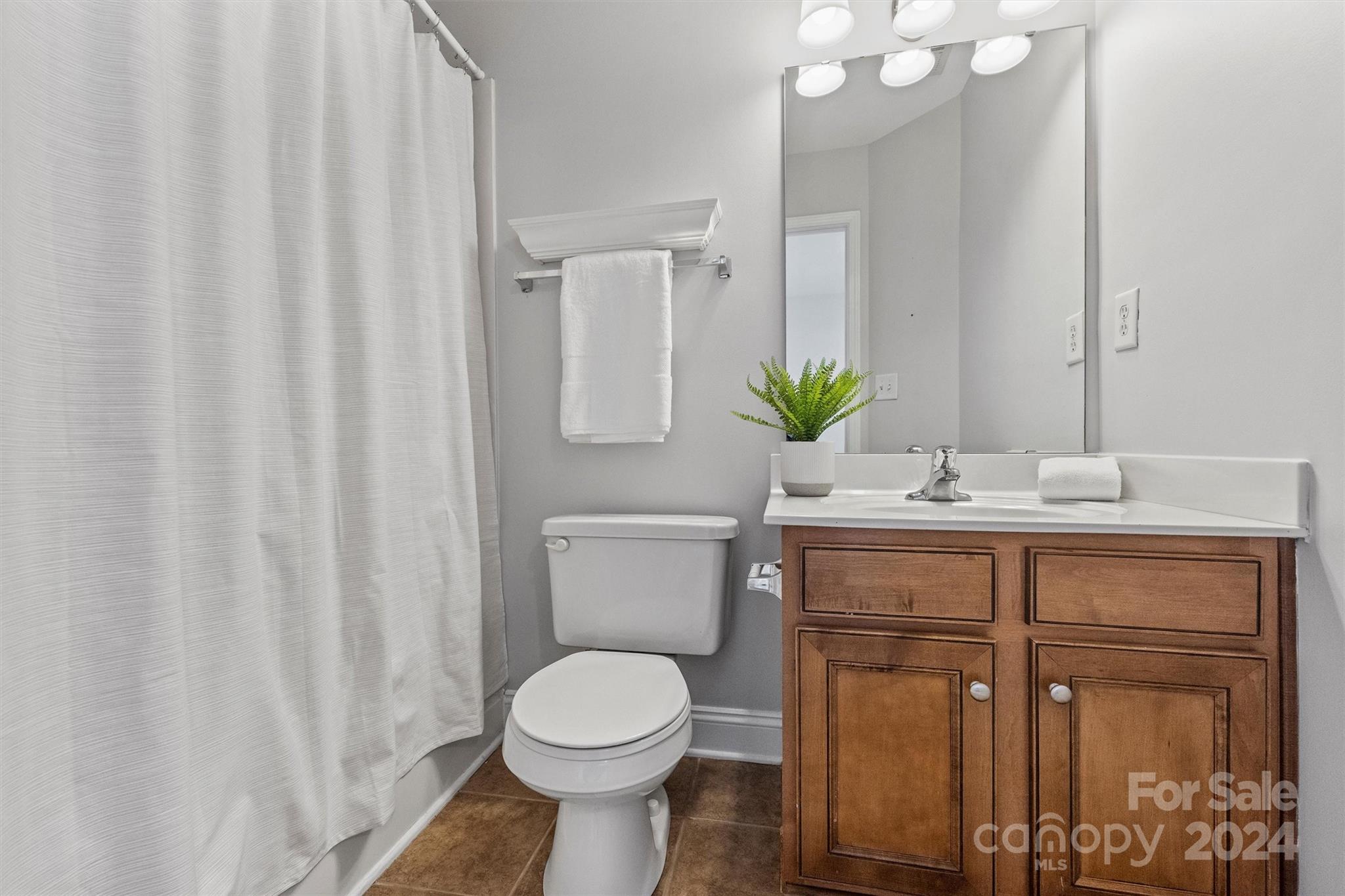323 Hurston Circle Charlotte, NC 28208 - Photo 19 of 27 a bathroom with a sink a toilet and a mirror