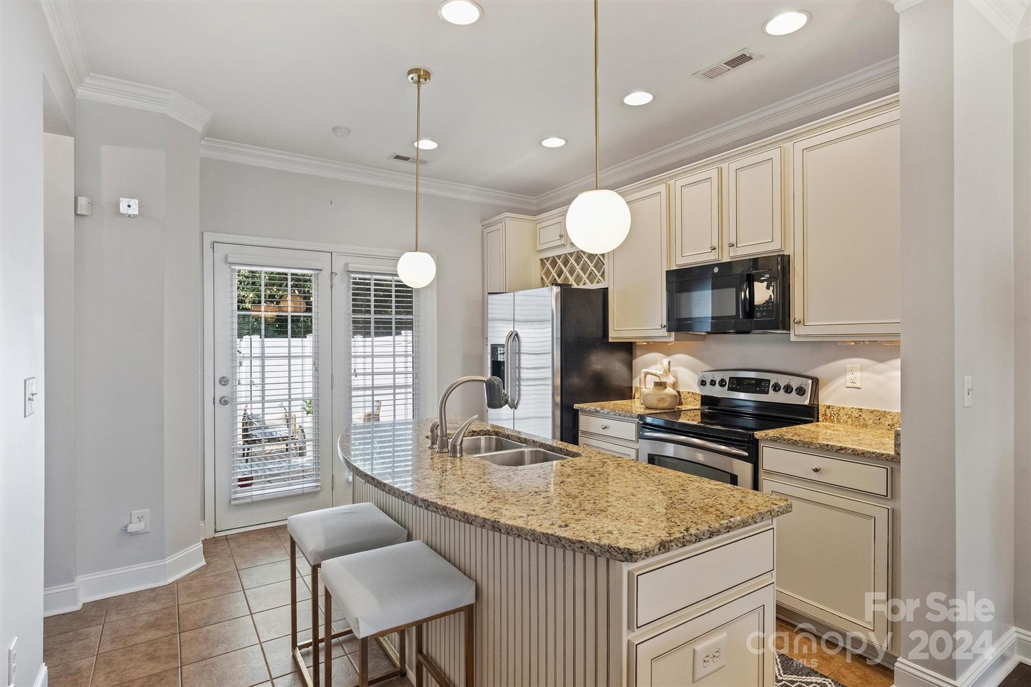 323 Hurston Circle Charlotte, NC 28208 - Photo 7 of 27 a kitchen with stainless steel appliances granite countertop a stove top oven a sink dishwasher a dining table and chairs with wooden floor
