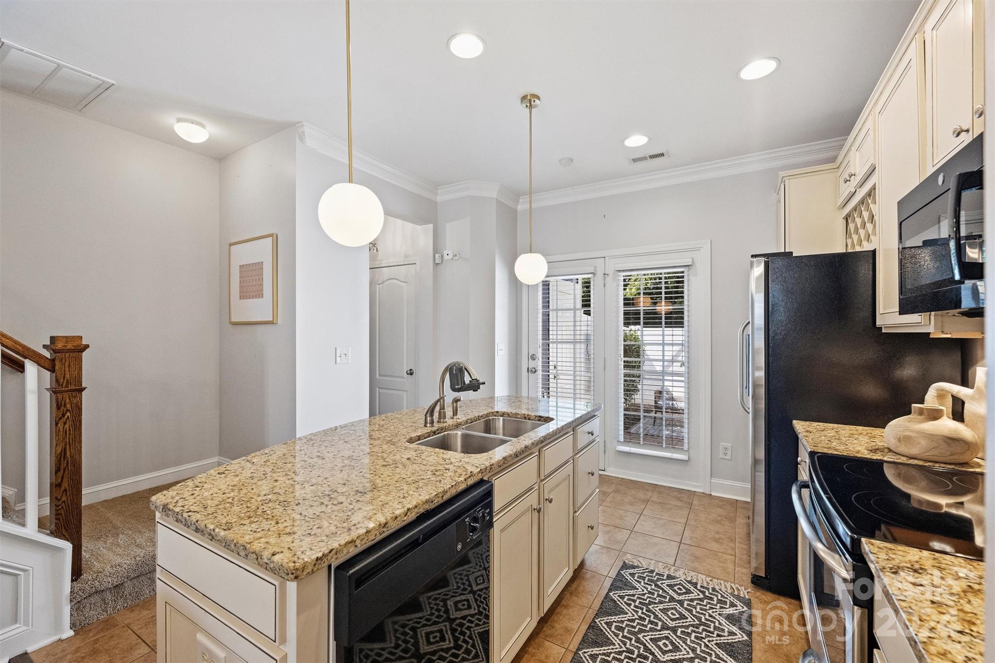 323 Hurston Circle Charlotte, NC 28208 - Photo 10 of 27 a kitchen with stainless steel appliances granite countertop a sink stove and refrigerator