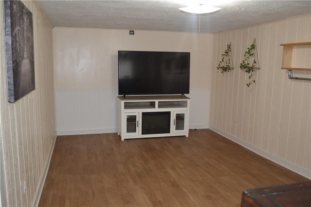 138 Mowl Road Washington, PA 15301 - Photo 13 of 43 a living room with a flat screen tv a fireplace and entryway