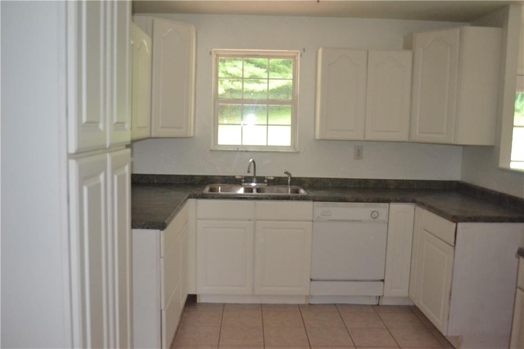 138 Mowl Road Washington, PA 15301 - Photo 32 of 43 a kitchen with white cabinets and window