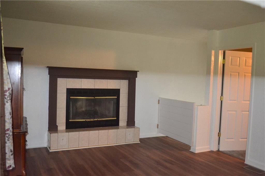 138 Mowl Road Washington, PA 15301 - Photo 37 of 43 a view of an empty room with wooden floor fireplace and a window
