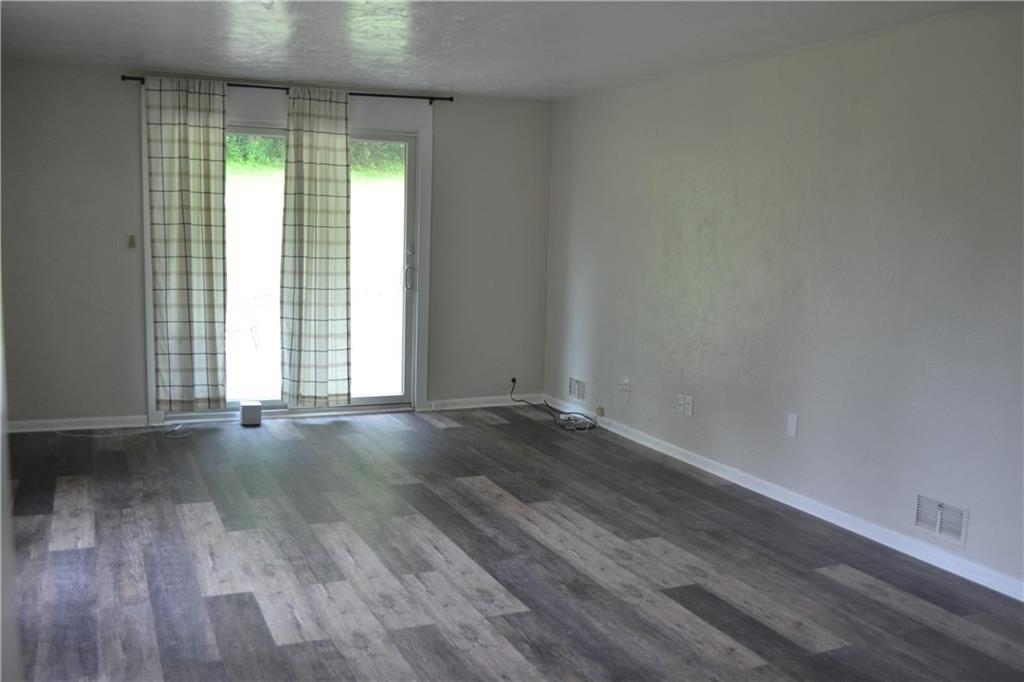 138 Mowl Road Washington, PA 15301 - Photo 8 of 43 an empty room with wooden floor and windows