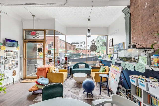a very nice looking living room with a large window and a chandelier