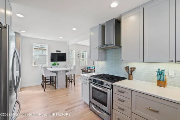 a kitchen with stainless steel appliances a stove a sink refrigerator and cabinets