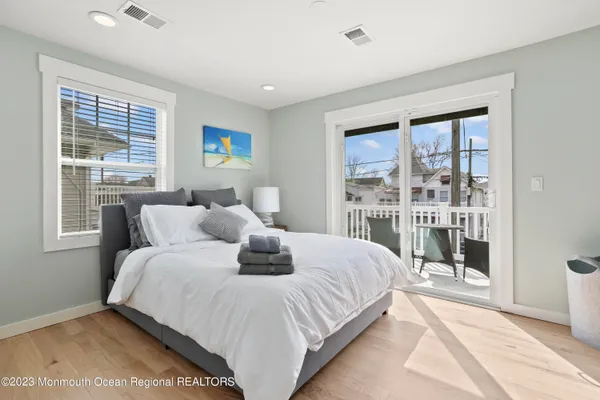 a bedroom with a large bed and a window
