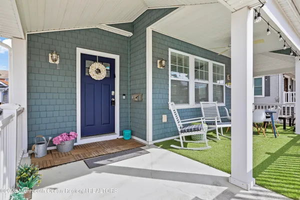 a living room with furniture a dining table and a window