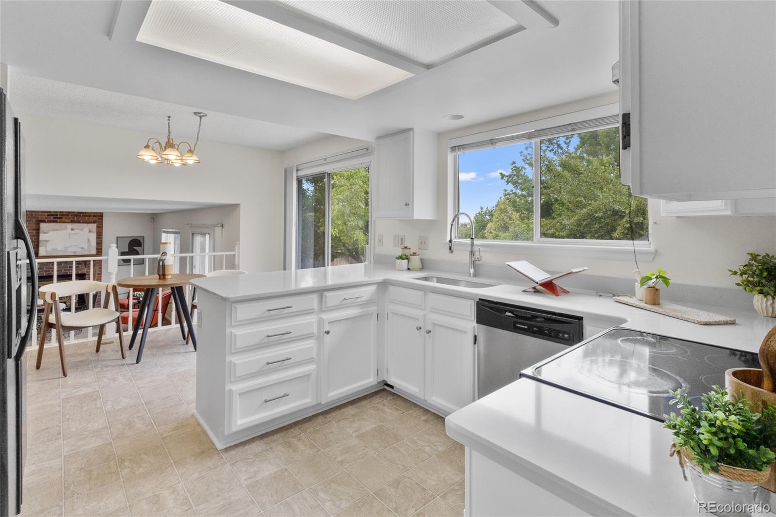 8441 Timberwood Street Highlands Ranch, CO 80126 - Photo 11 of 32 a kitchen with white cabinets and a stove