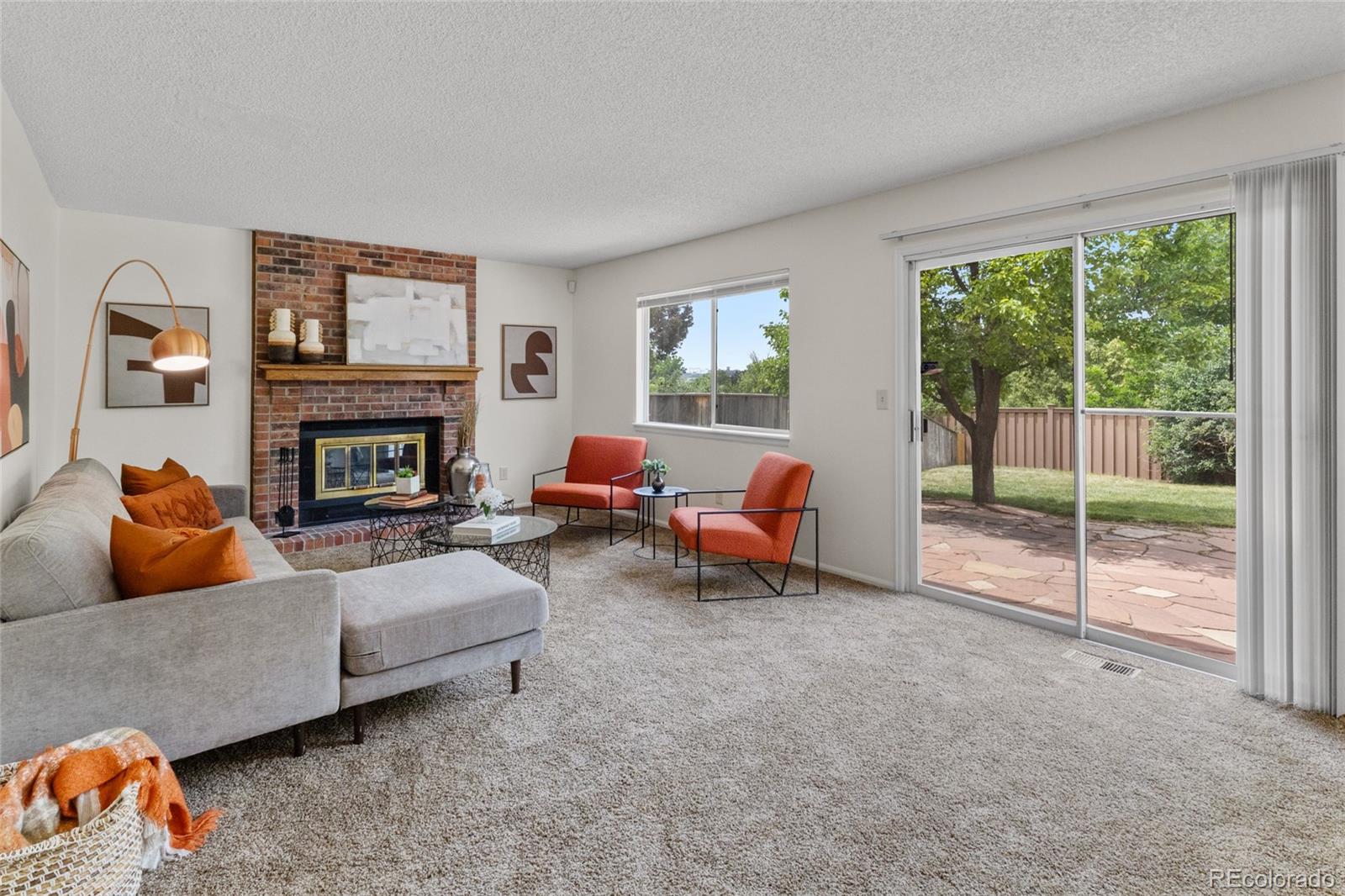 8441 Timberwood Street Highlands Ranch, CO 80126 - Photo 12 of 32 a living room with furniture and a fireplace