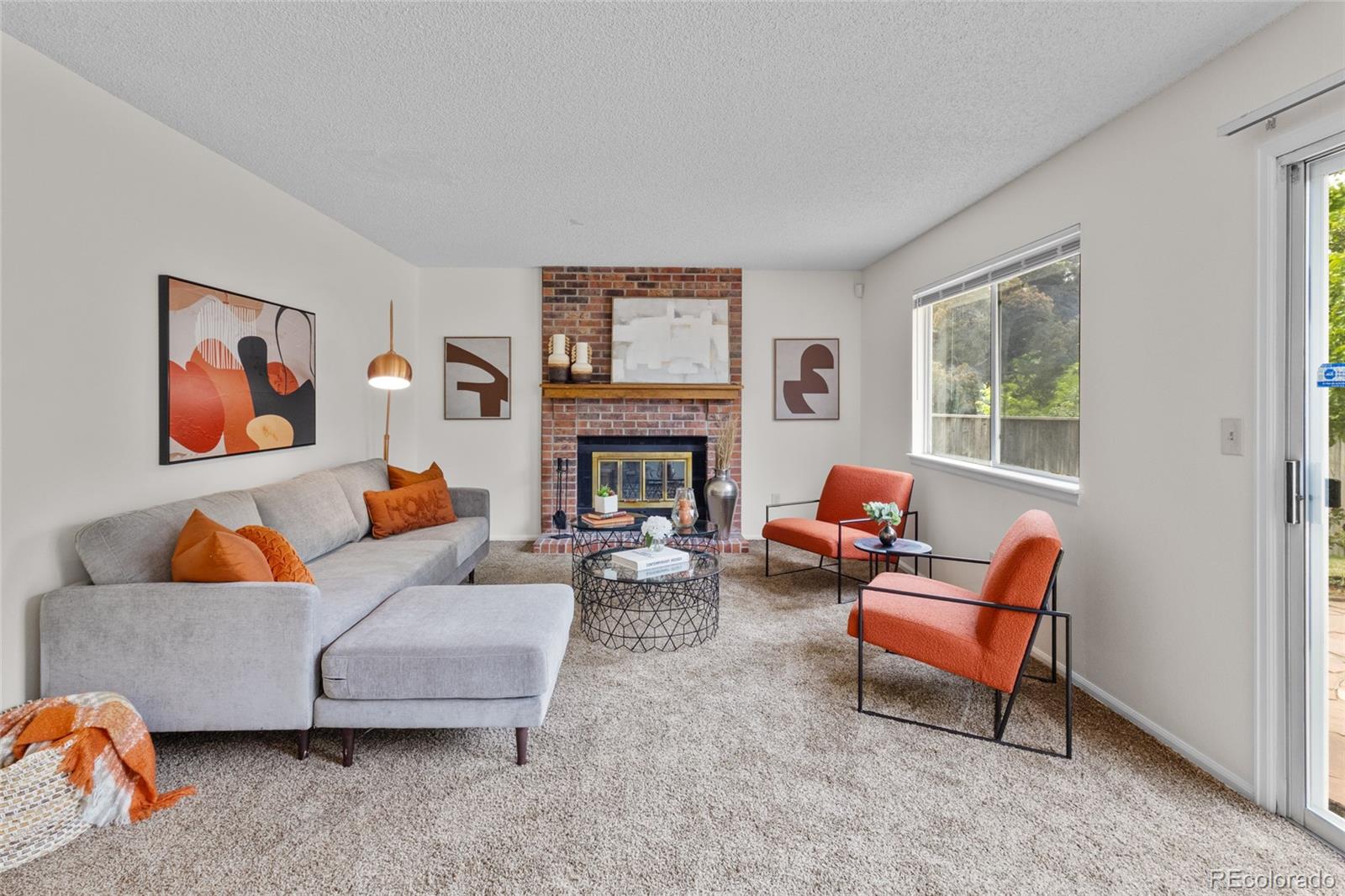 8441 Timberwood Street Highlands Ranch, CO 80126 - Photo 13 of 32 a living room with furniture and a fireplace