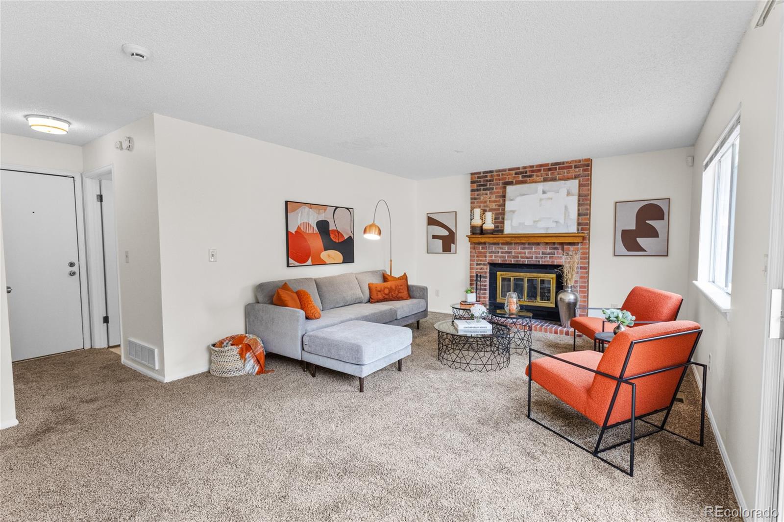 8441 Timberwood Street Highlands Ranch, CO 80126 - Photo 14 of 32 a living room with furniture and a fireplace