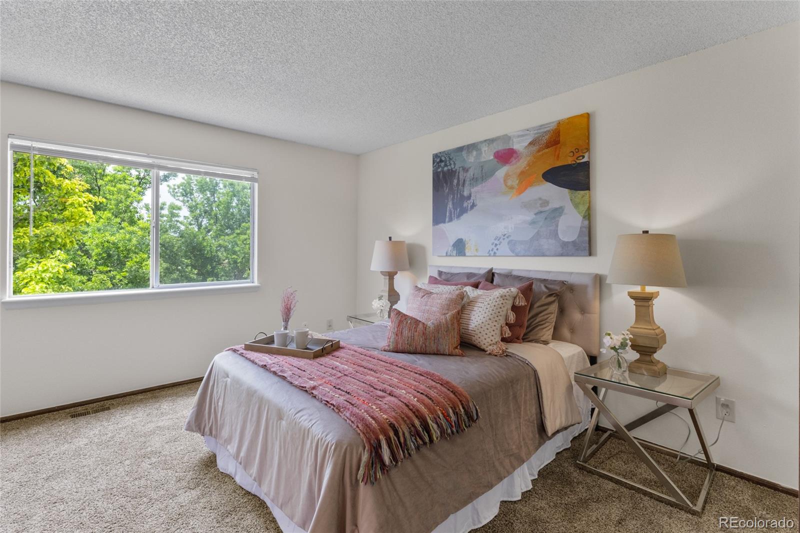 8441 Timberwood Street Highlands Ranch, CO 80126 - Photo 18 of 32 a bedroom with a bed and a painting on the wall