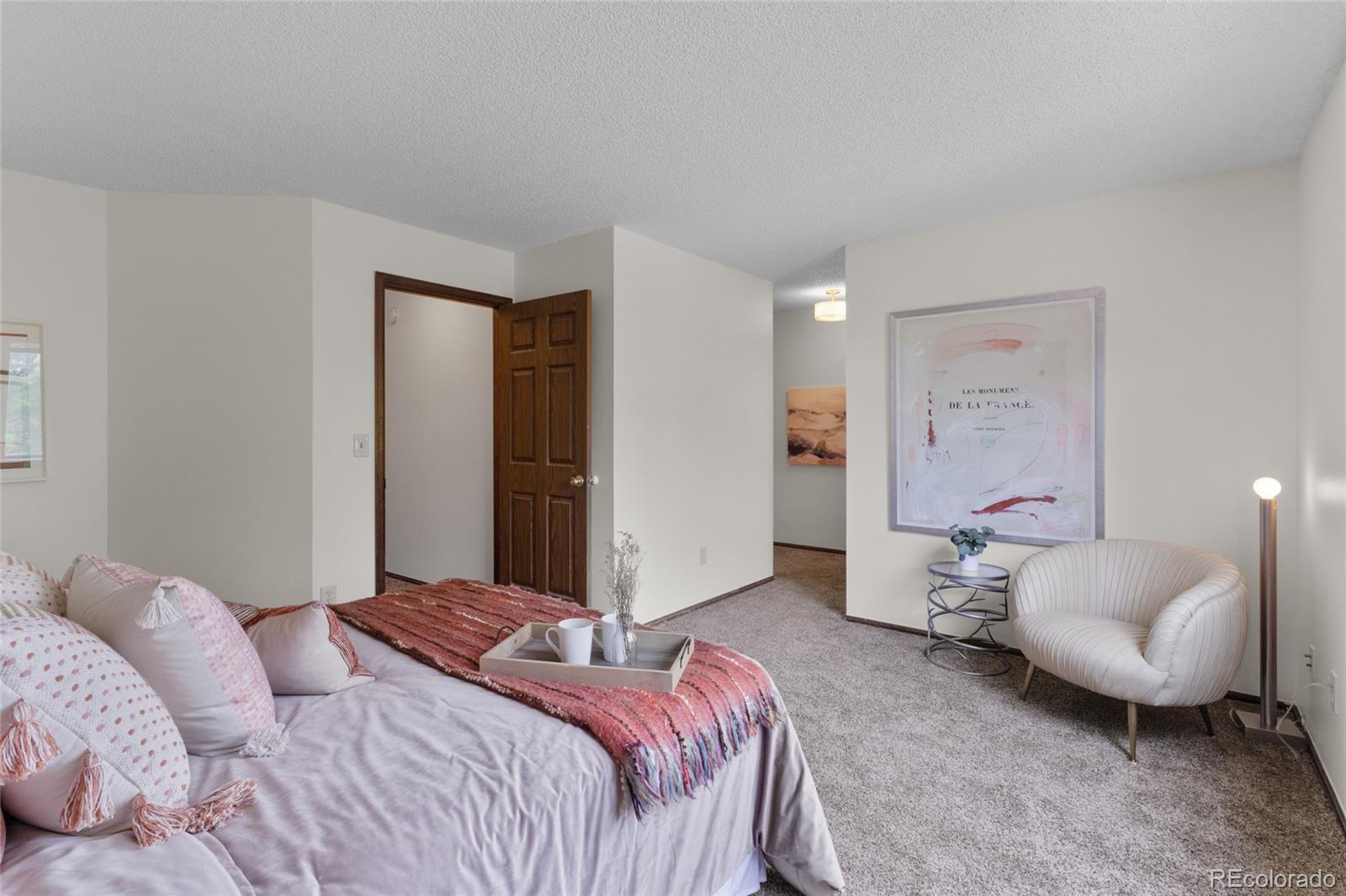 8441 Timberwood Street Highlands Ranch, CO 80126 - Photo 19 of 32 a bedroom with a bed and furniture