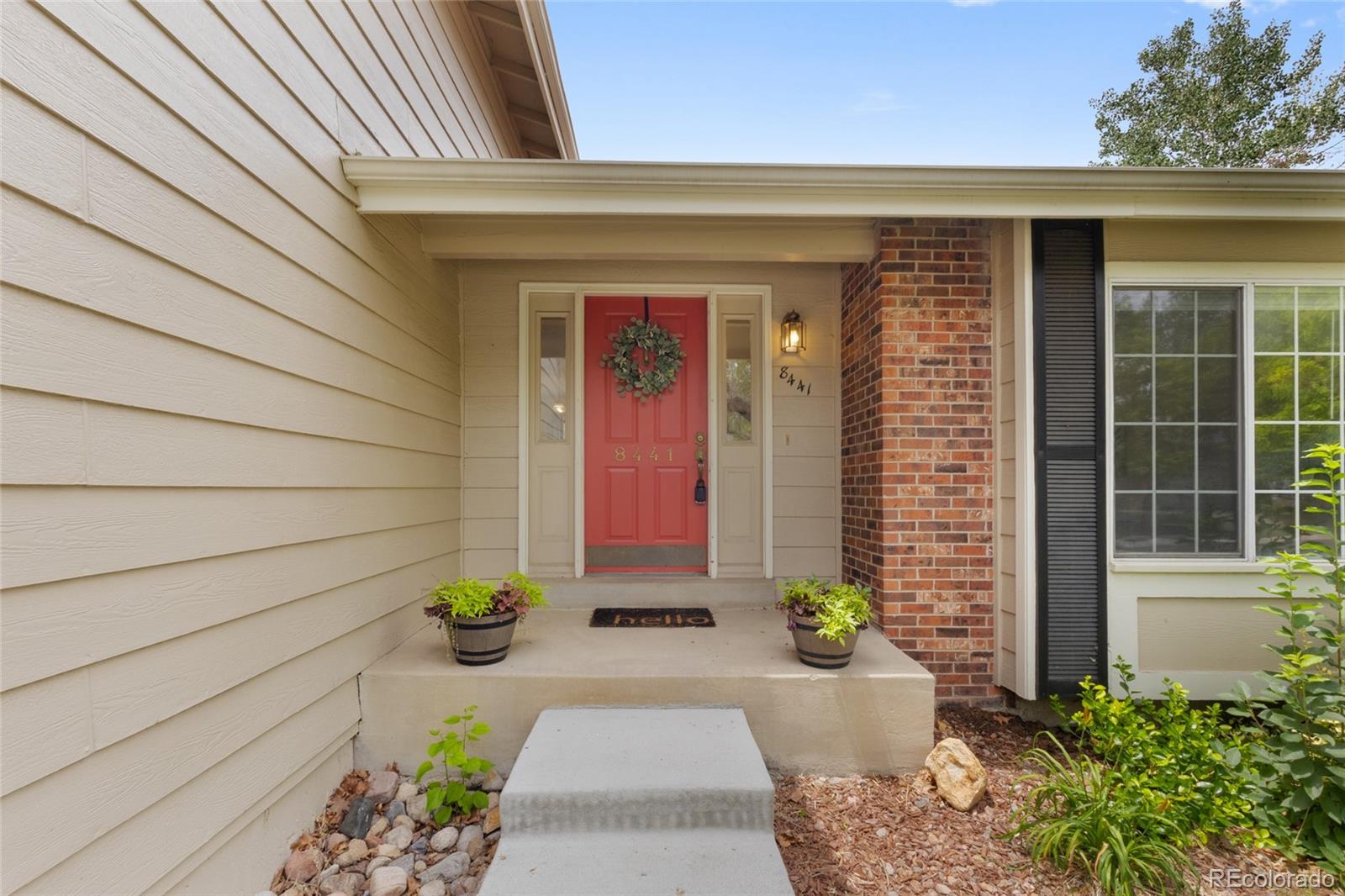 8441 Timberwood Street Highlands Ranch, CO 80126 - Photo 2 of 32 a front view of a house with a garden