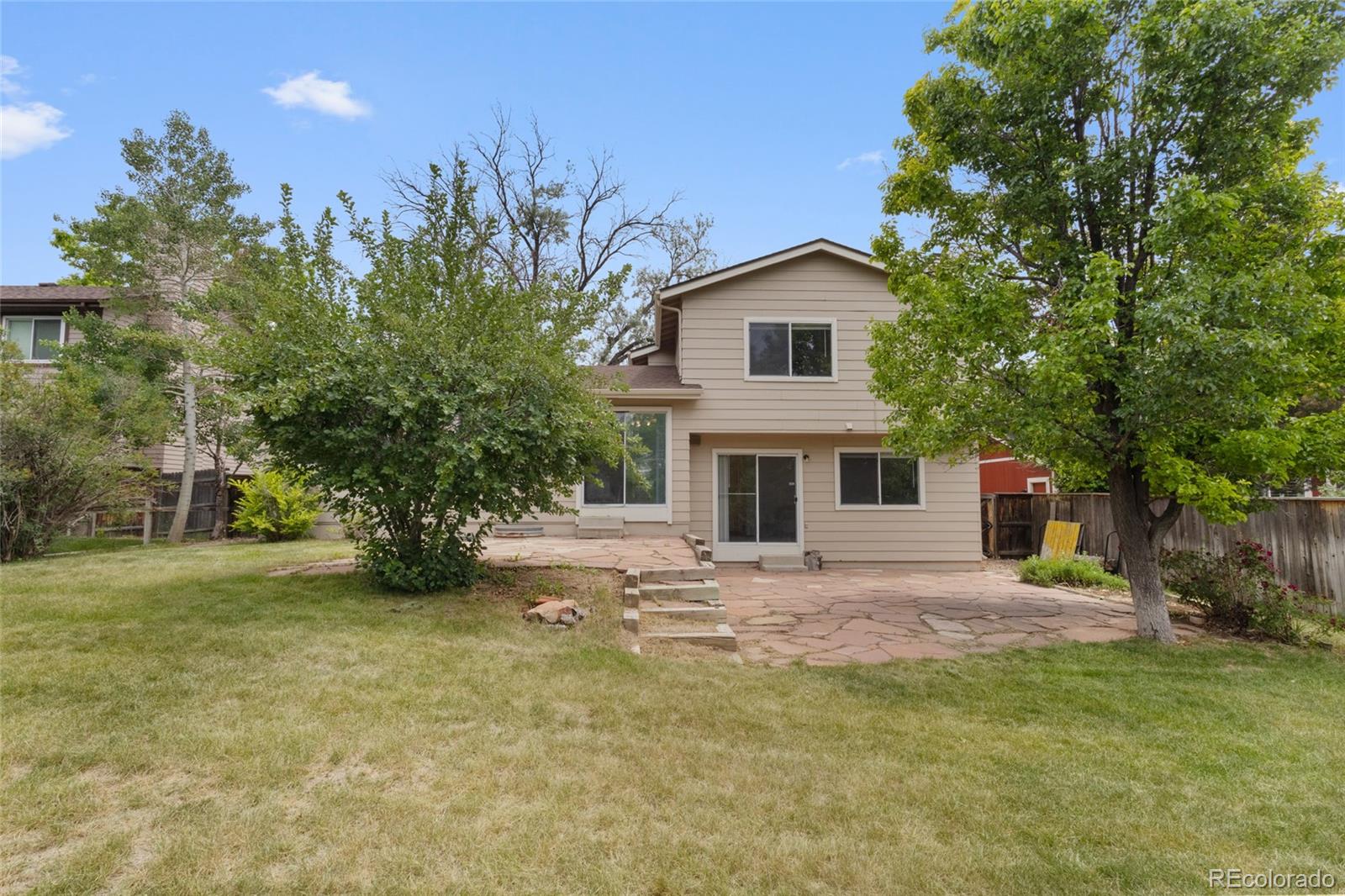 8441 Timberwood Street Highlands Ranch, CO 80126 - Photo 28 of 32 a view of a house with a yard and garage