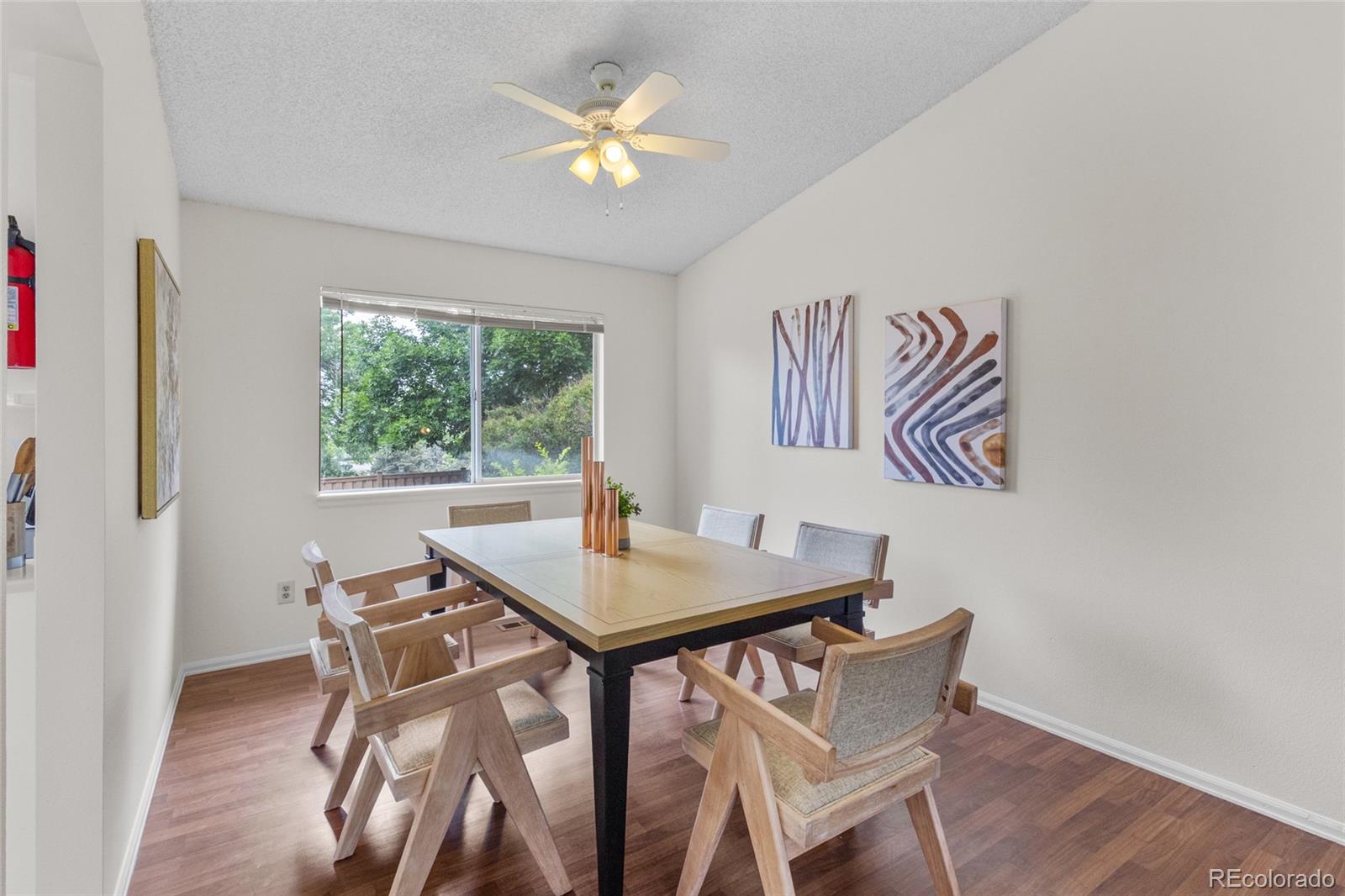 8441 Timberwood Street Highlands Ranch, CO 80126 - Photo 6 of 32 a view of a dining room with furniture a chandelier and wooden floor