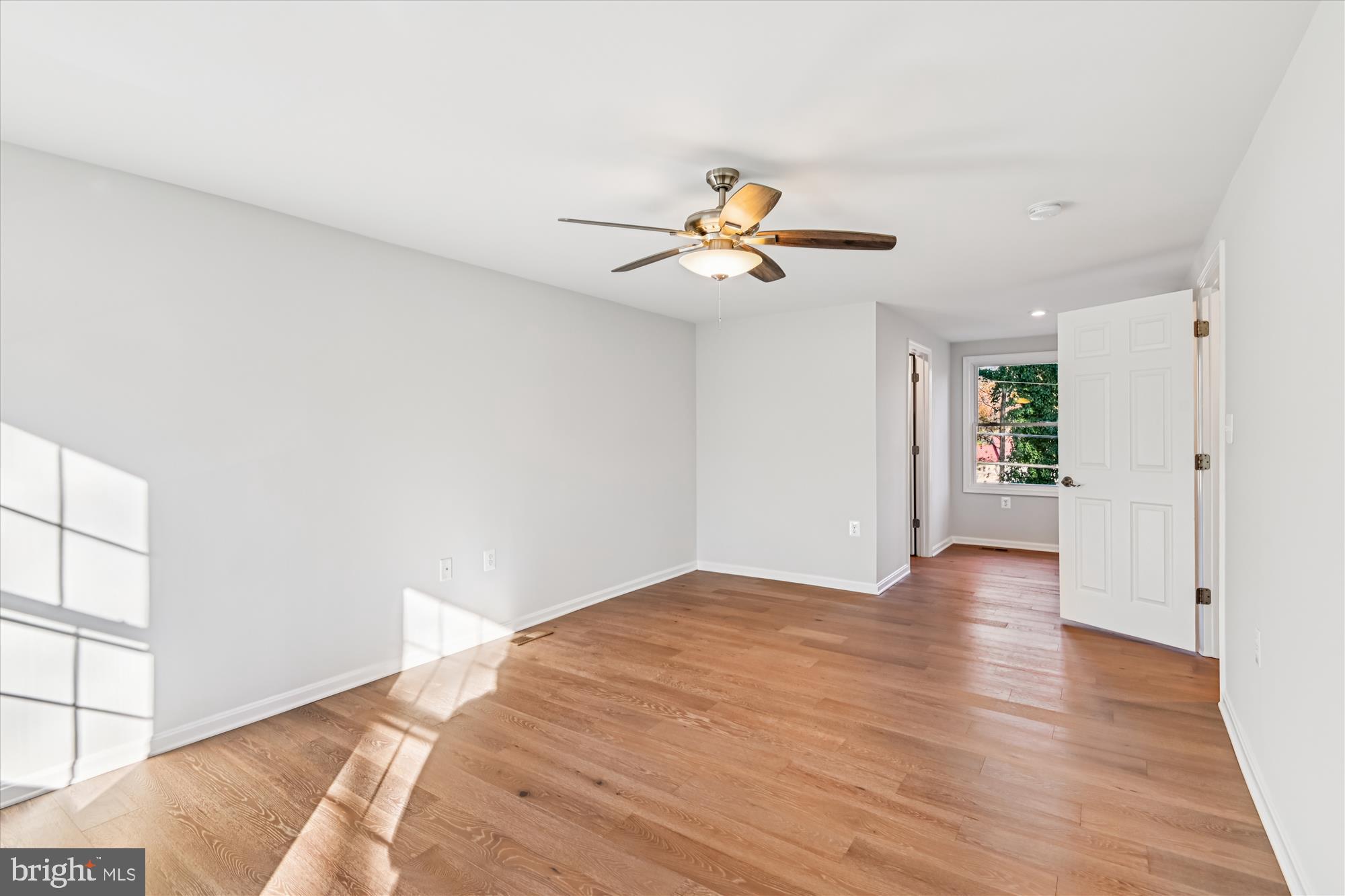 3092 Sussex Place Riva, MD 21140 - Photo 57 of 105 a view of an empty room with window and wooden floor