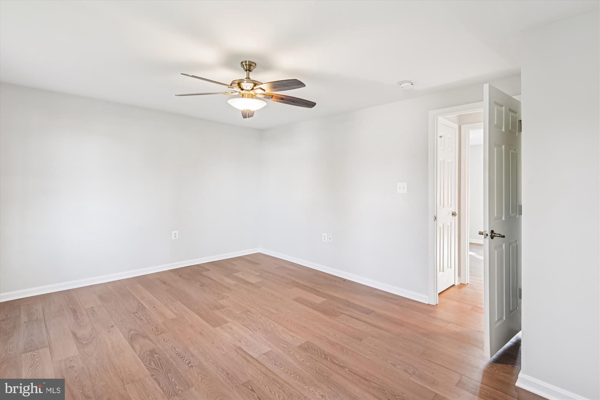 3092 Sussex Place Riva, MD 21140 - Photo 65 of 105 an empty room with wooden floor fan and windows