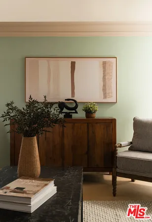 a bedroom with a bed couch and a large window