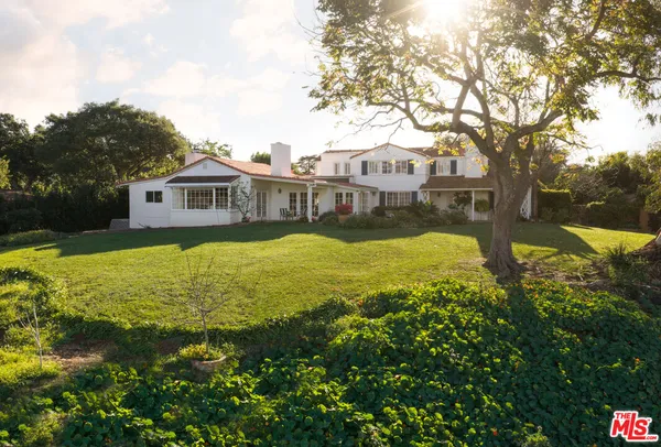 a view of a house with swimming pool and garden