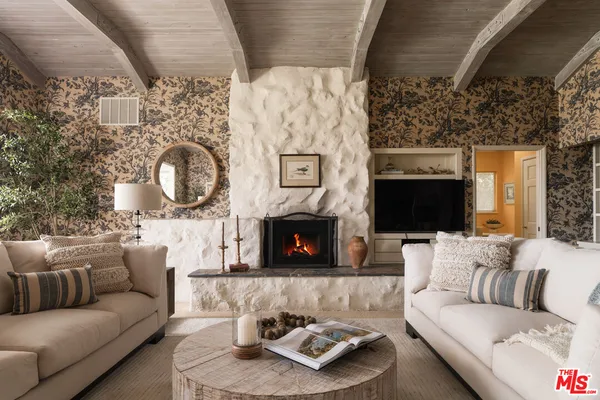 a living room with furniture and a floor to ceiling window