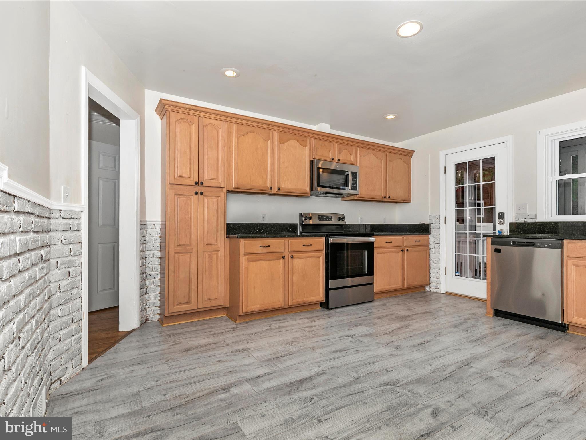 8913 Yellow Springs Road Frederick, MD 21702 - Photo 11 of 77 a kitchen with stainless steel appliances granite countertop a stove top oven a sink and a refrigerator