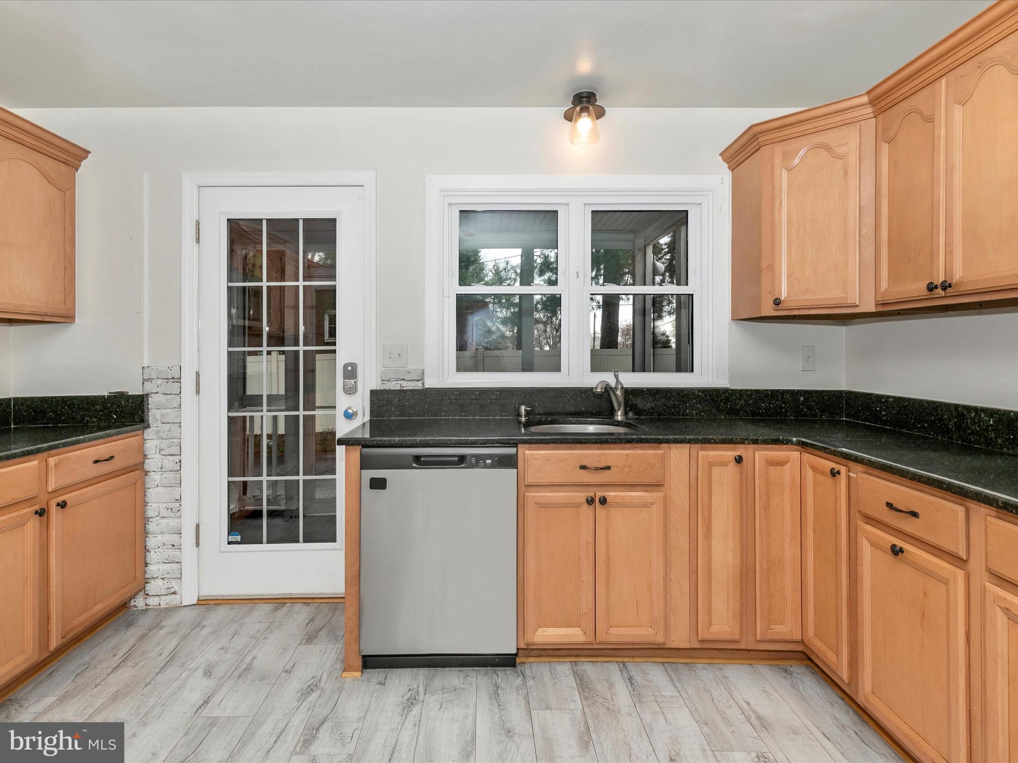 8913 Yellow Springs Road Frederick, MD 21702 - Photo 13 of 77 a kitchen with stainless steel appliances granite countertop a sink and cabinets with wooden floors