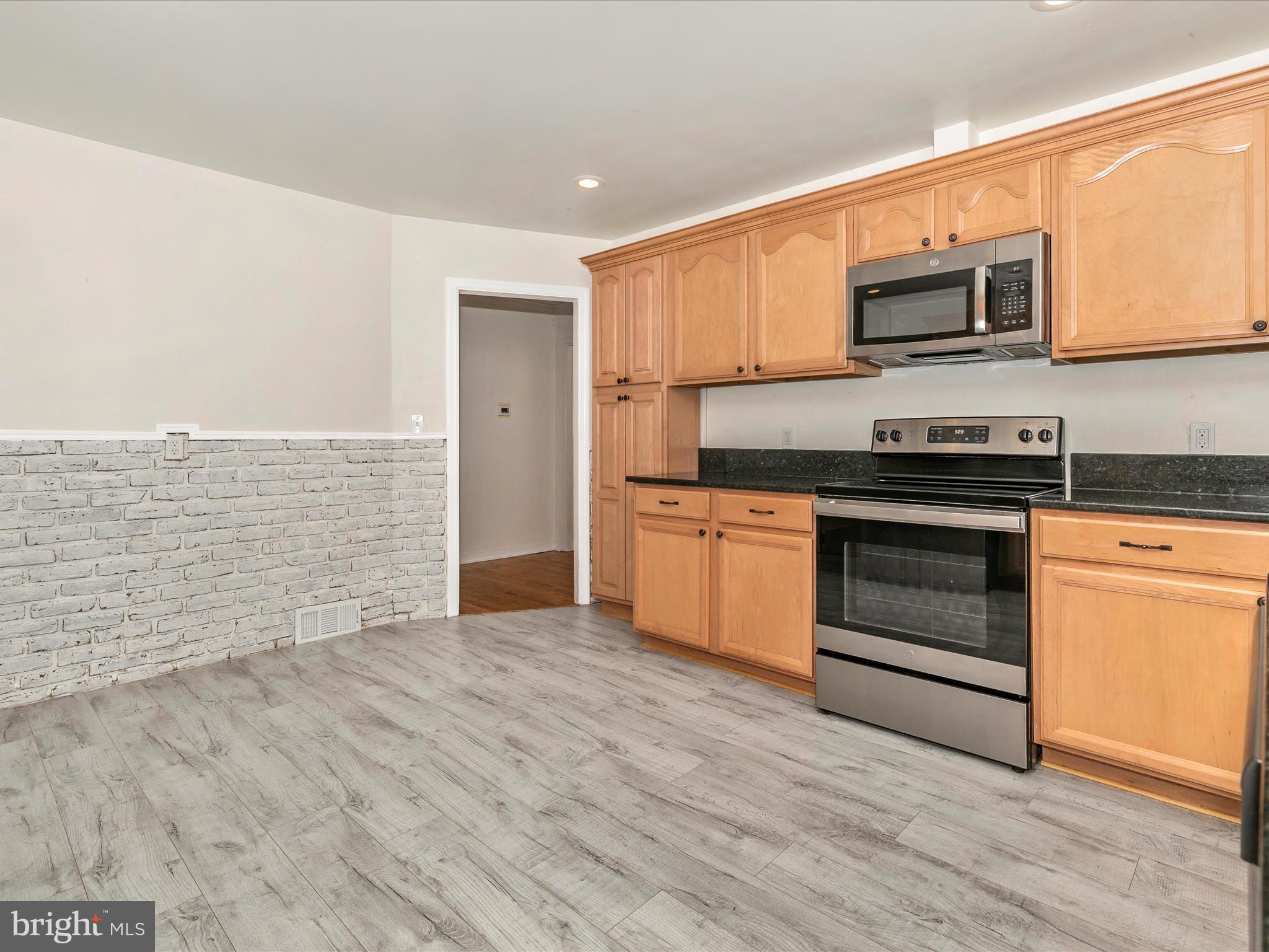 8913 Yellow Springs Road Frederick, MD 21702 - Photo 17 of 77 a kitchen with stainless steel appliances granite countertop a stove top oven and sink