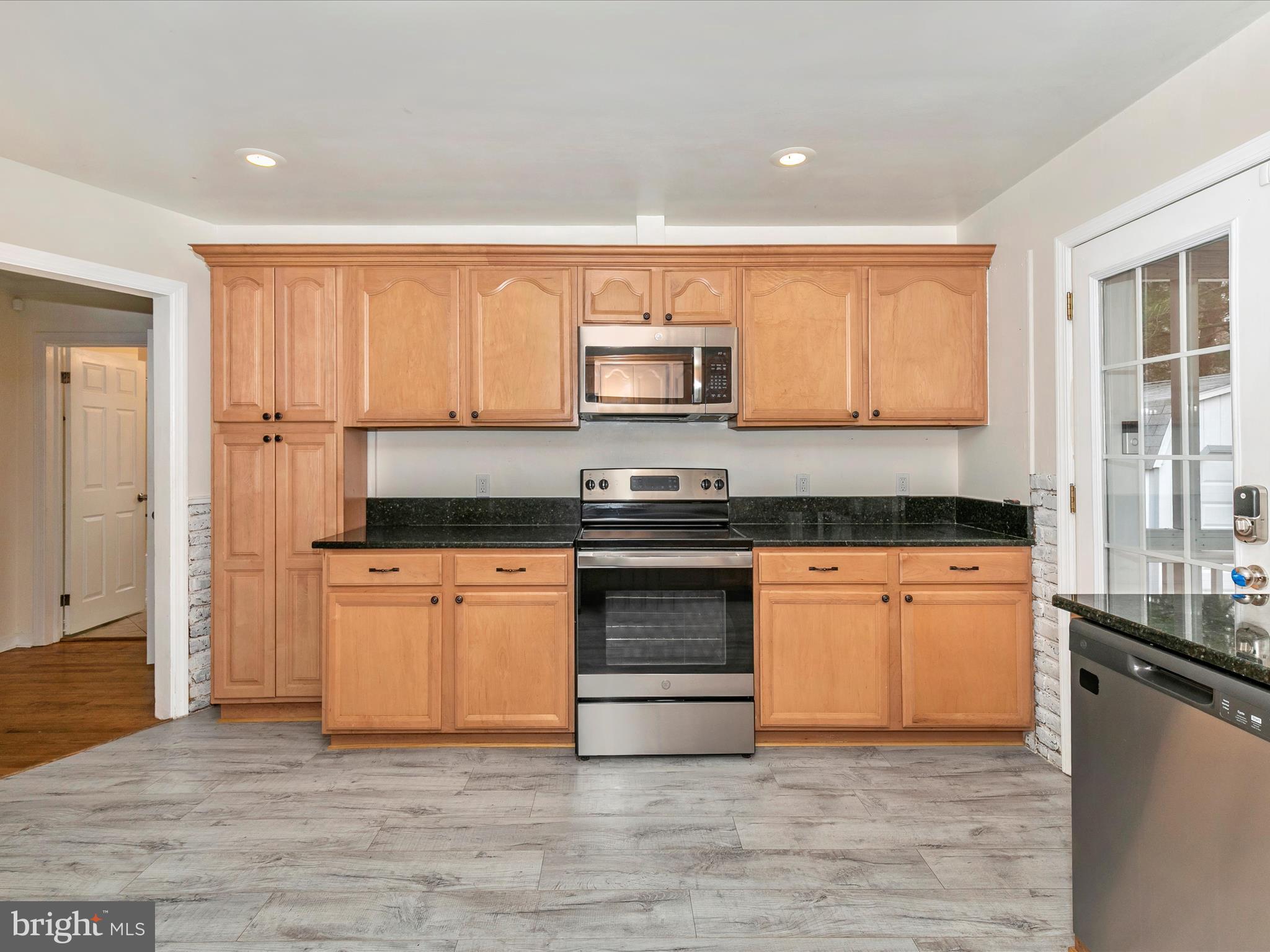 8913 Yellow Springs Road Frederick, MD 21702 - Photo 18 of 77 a kitchen with stainless steel appliances granite countertop a stove a sink and a refrigerator
